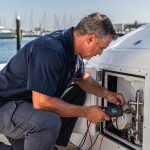 Marine technician diagnosing a boat refrigerator not cooling at a San Diego marina